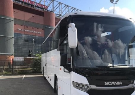 White coach parked at Manchester United football stadium