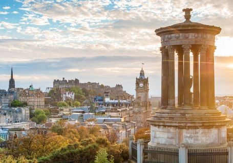 The Edinburgh skyline, with the Dugald Stewart monument in the foreground and Edinburgh Castle in the background.