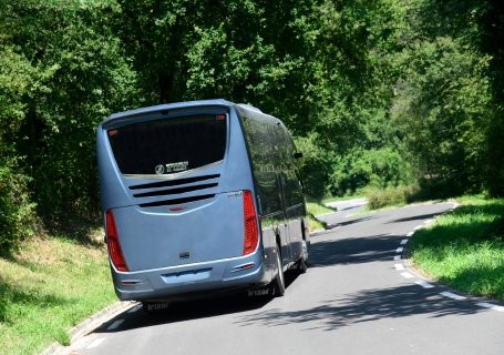 Grey coach travelling along the road