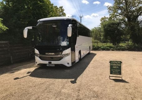 White coach parked in a car park