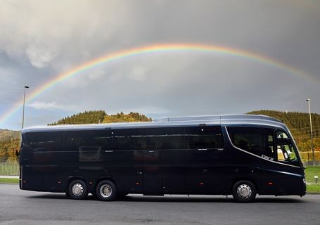 Large coach with a rainbow above