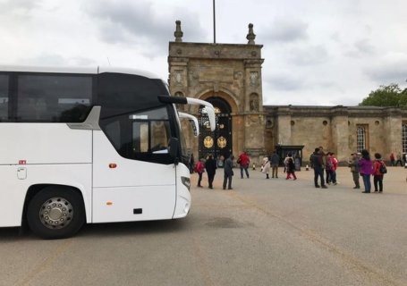 White coach and people in the background